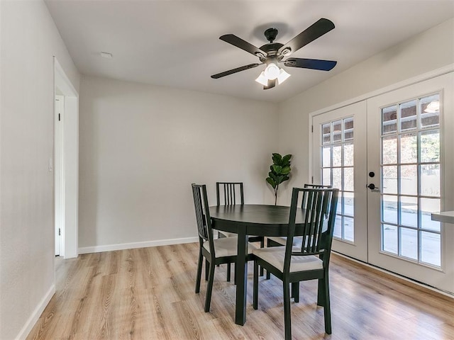 dining room featuring ceiling fan, french doors, and light hardwood / wood-style floors