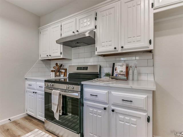 kitchen featuring white cabinets, decorative backsplash, light hardwood / wood-style flooring, and stainless steel stove