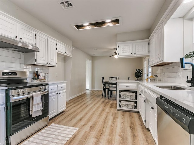 kitchen featuring sink, ceiling fan, decorative backsplash, appliances with stainless steel finishes, and white cabinetry