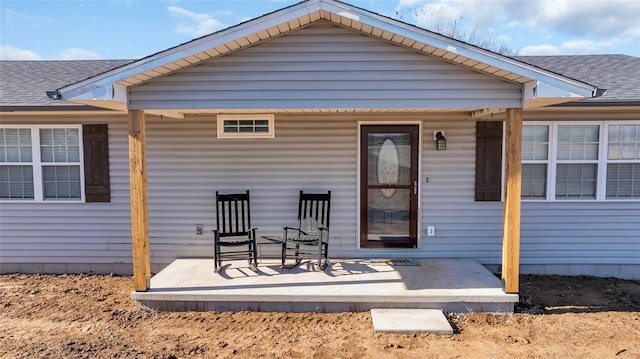 back of house featuring a porch