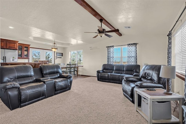 carpeted living room with vaulted ceiling with beams, ceiling fan, french doors, and a textured ceiling