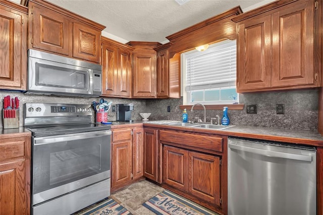 kitchen with sink, stainless steel appliances, and tasteful backsplash