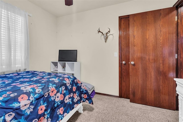 bedroom featuring ceiling fan and light carpet