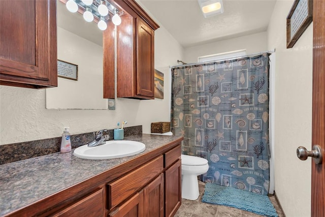 bathroom with vanity, a shower with shower curtain, and toilet