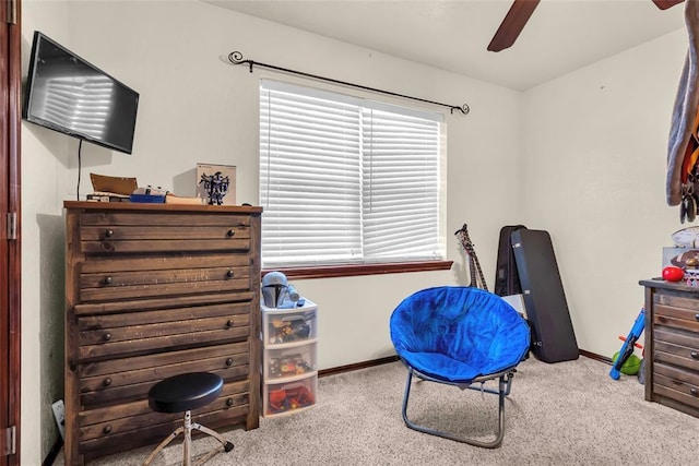 carpeted home office with ceiling fan