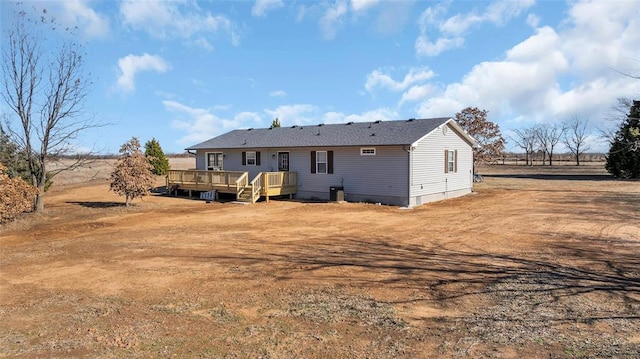 rear view of property featuring a wooden deck and a rural view