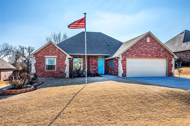 view of front facade with a front yard and a garage