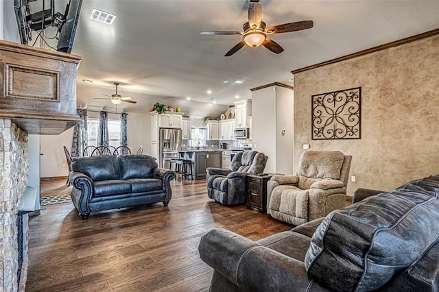 living room with ceiling fan, dark hardwood / wood-style floors, and ornamental molding