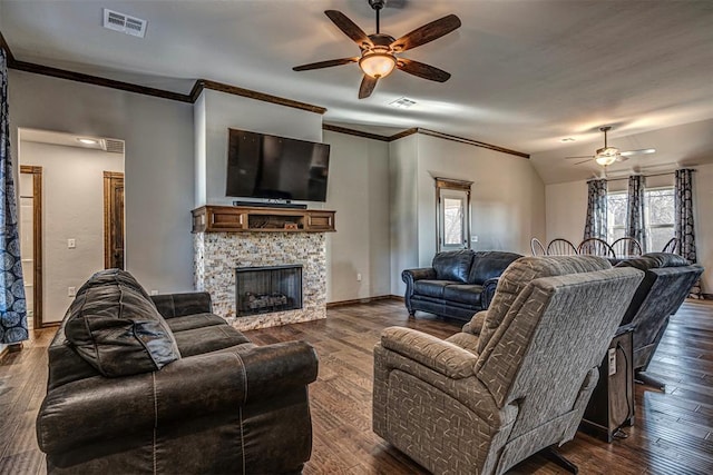 living room featuring lofted ceiling, a stone fireplace, ceiling fan, and dark hardwood / wood-style floors