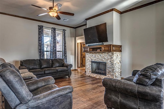 living room with dark hardwood / wood-style flooring, ceiling fan, crown molding, a stone fireplace, and lofted ceiling