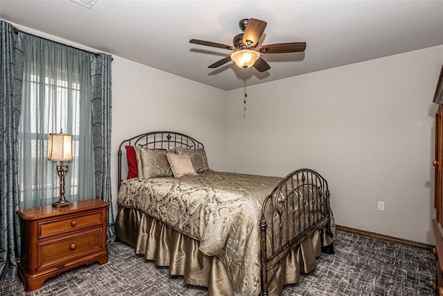 bedroom featuring ceiling fan and dark carpet