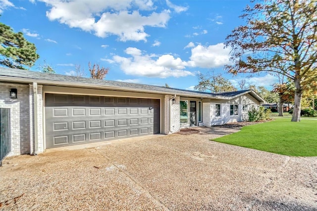 ranch-style home featuring a garage and a front lawn