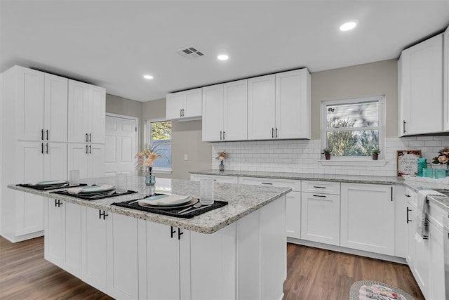 kitchen featuring white cabinets and a center island