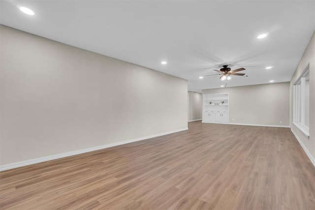 empty room featuring ceiling fan and light wood-type flooring