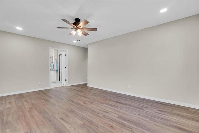 empty room featuring ceiling fan and light hardwood / wood-style floors