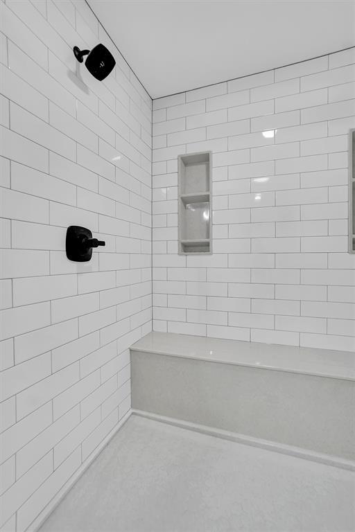 bathroom with a tile shower