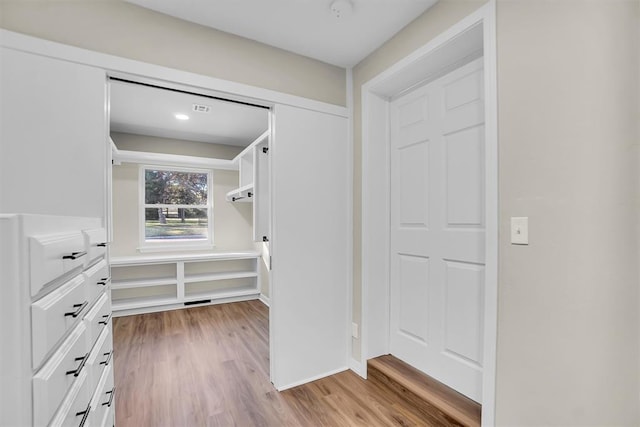 walk in closet with light wood-type flooring