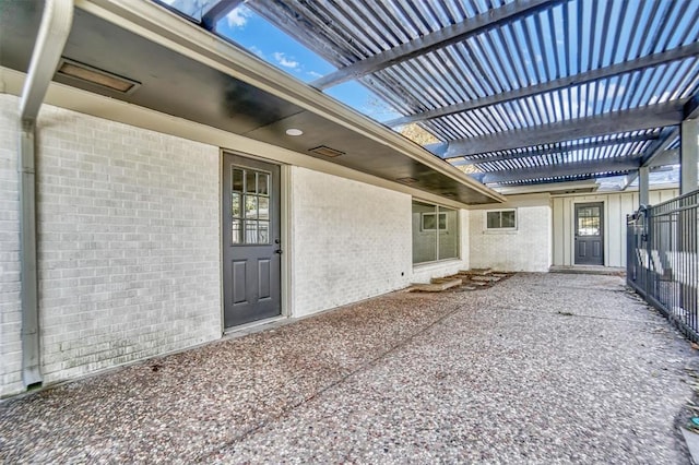 property entrance featuring a pergola