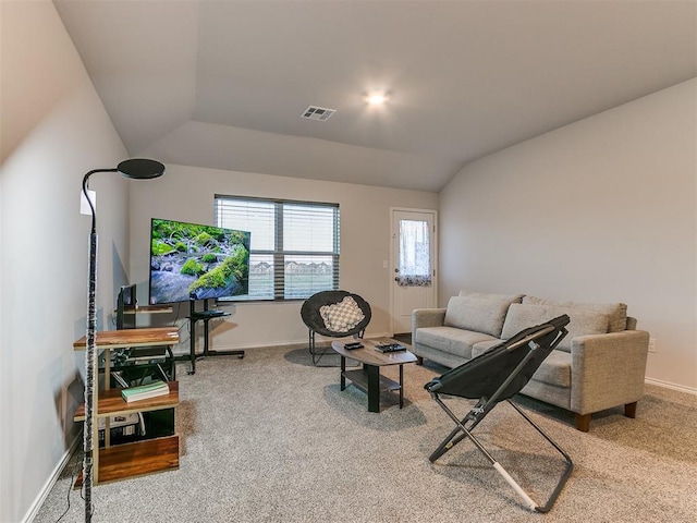 carpeted living room featuring lofted ceiling