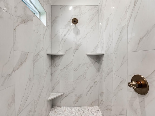 bathroom with tiled shower