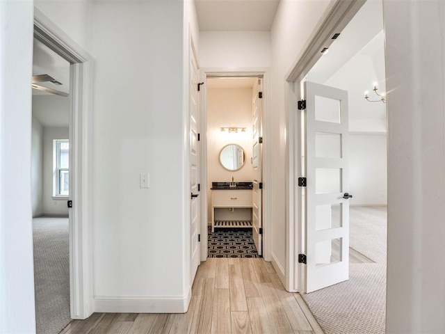 hallway with light hardwood / wood-style floors