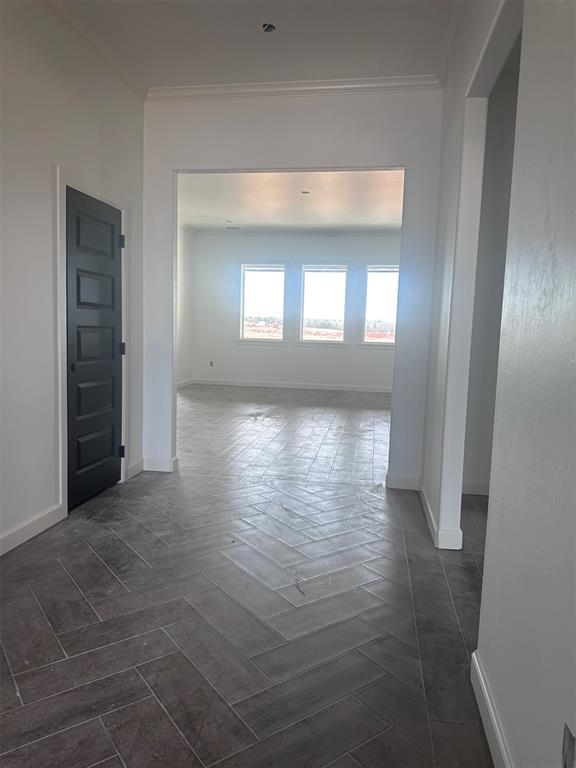 unfurnished room featuring crown molding