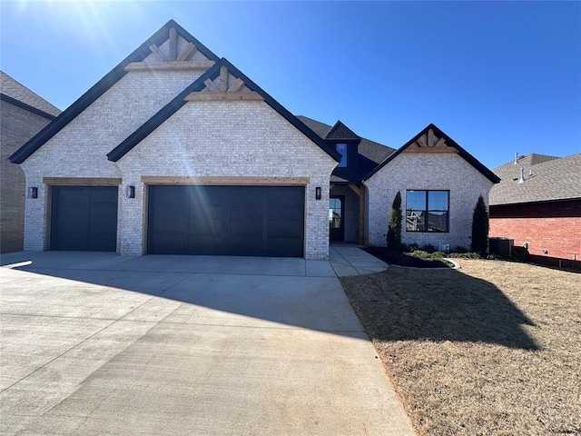 view of front of property with brick siding, driveway, and an attached garage