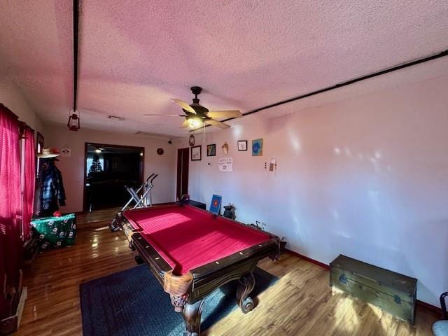 game room featuring ceiling fan, wood-type flooring, a textured ceiling, and pool table