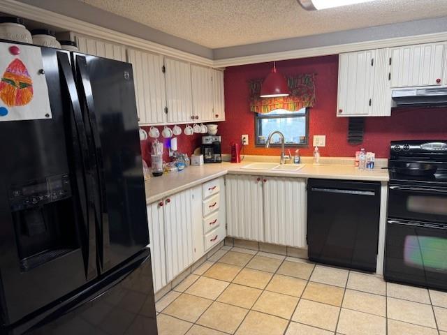 kitchen with sink, ventilation hood, white cabinetry, and black appliances