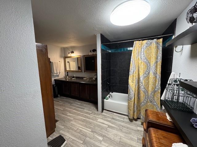 bathroom with hardwood / wood-style floors, vanity, a textured ceiling, and shower / tub combo with curtain