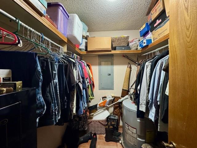 walk in closet featuring electric water heater and electric panel