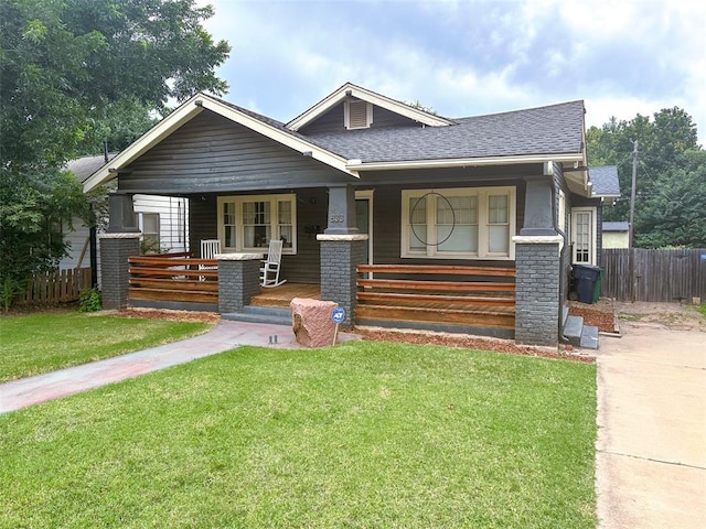 craftsman house with covered porch and a front lawn