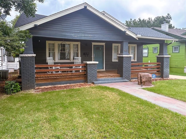 view of front of house featuring covered porch and a front lawn