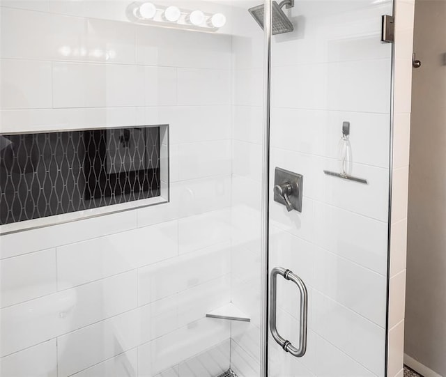 bathroom with a shower with door