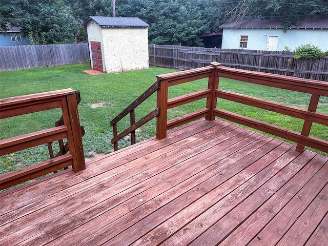 wooden deck with a yard and a shed