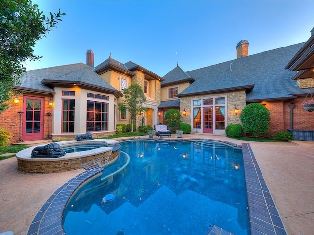 view of swimming pool with an in ground hot tub and a patio