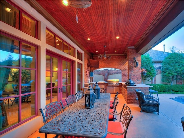 view of patio / terrace featuring french doors, a grill, and exterior kitchen