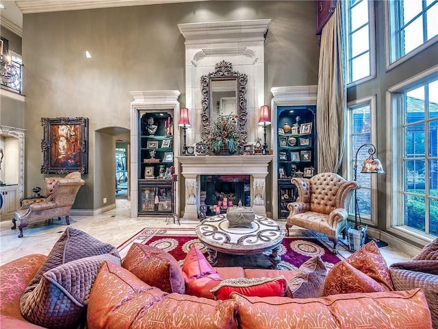 living room with a high ceiling and ornamental molding