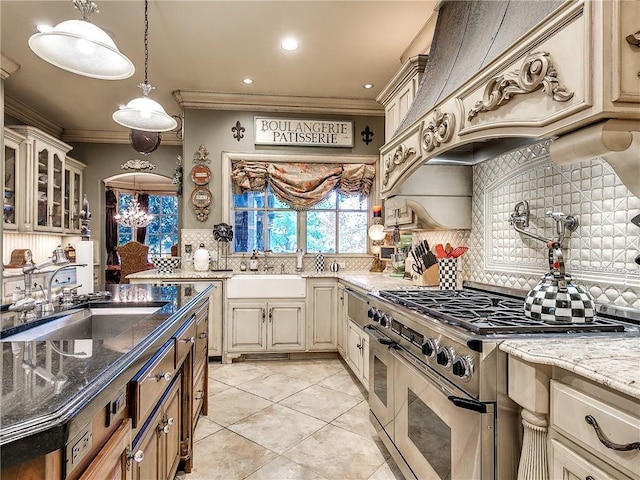 kitchen with sink, high end stainless steel range, dark stone countertops, ornamental molding, and tasteful backsplash