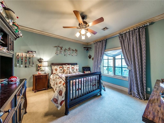 carpeted bedroom featuring ceiling fan and crown molding