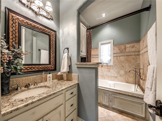 bathroom with tile patterned flooring, vanity, and a tub to relax in