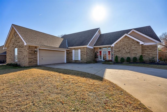 view of front of property with a garage and a front lawn