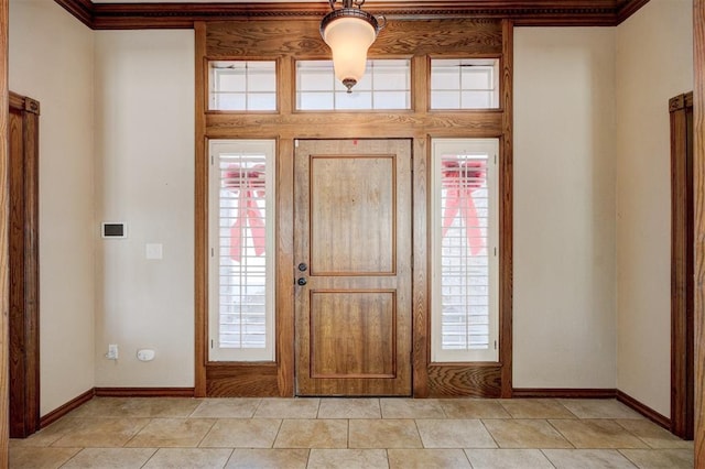 entryway featuring a wealth of natural light and crown molding