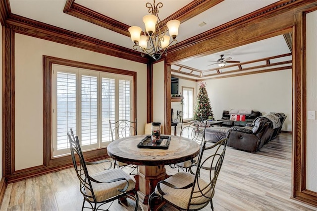 dining room featuring crown molding, light hardwood / wood-style floors, and ceiling fan with notable chandelier