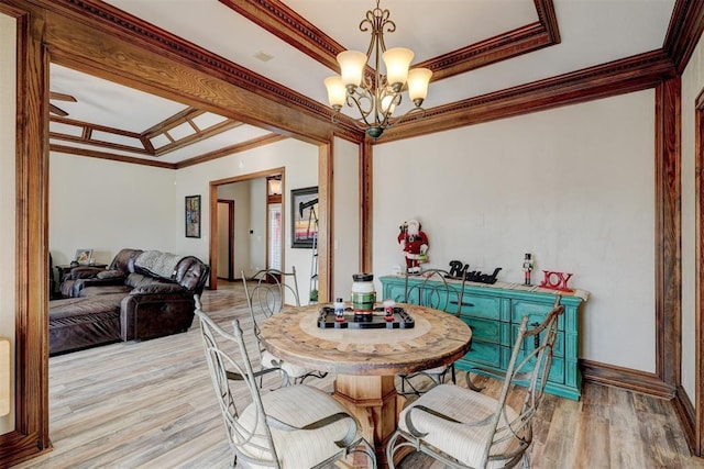 dining space featuring light hardwood / wood-style floors, crown molding, and a notable chandelier