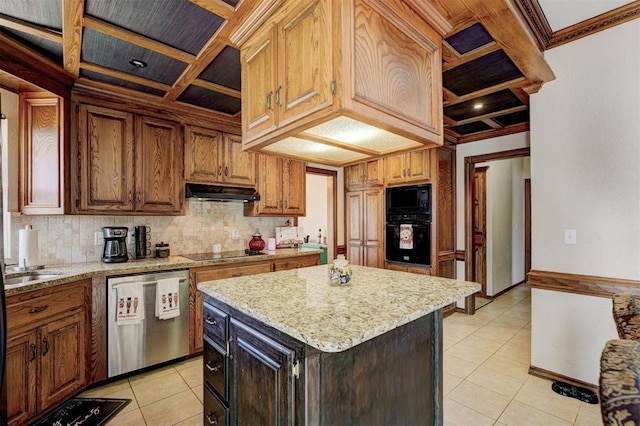 kitchen with light stone countertops, decorative backsplash, black appliances, light tile patterned floors, and a kitchen island