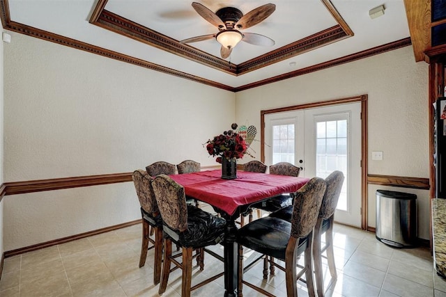 dining space featuring a tray ceiling, ceiling fan, french doors, and crown molding