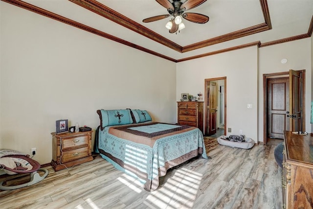 bedroom featuring light hardwood / wood-style floors, ceiling fan, and ornamental molding