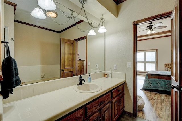 bathroom with vanity, ceiling fan, and ornamental molding