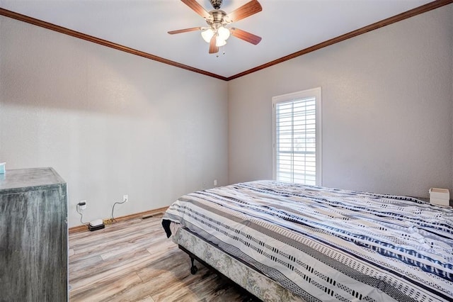 bedroom with ceiling fan, light hardwood / wood-style floors, and ornamental molding